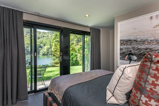 a bed sitting in a bedroom next to a window