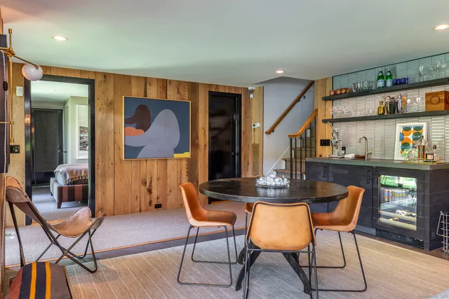 a dining room with furniture and wooden floor