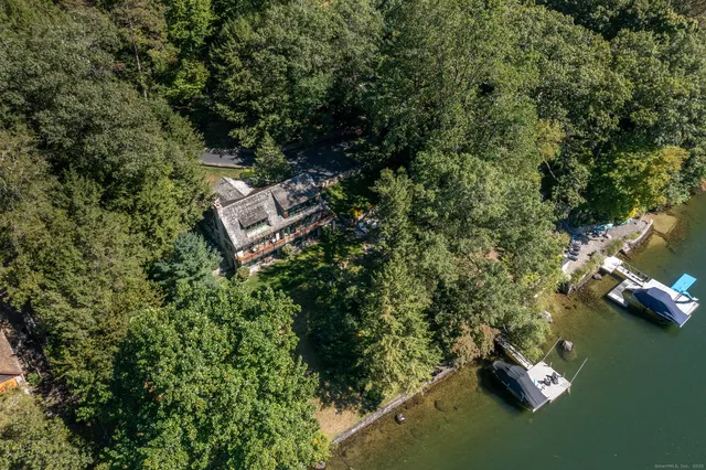 an aerial view of a house with a yard
