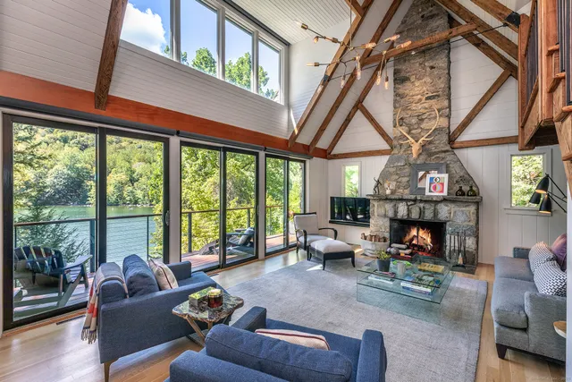 a living room with furniture fireplace and outdoor view
