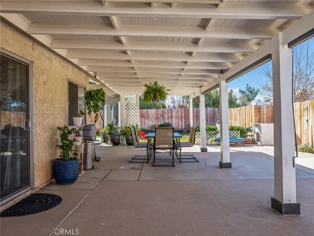 a view of a backyard with a small cabin and wooden fence