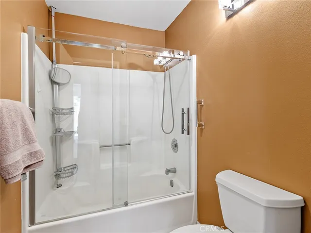 a bedroom with a bed and painting on the wall