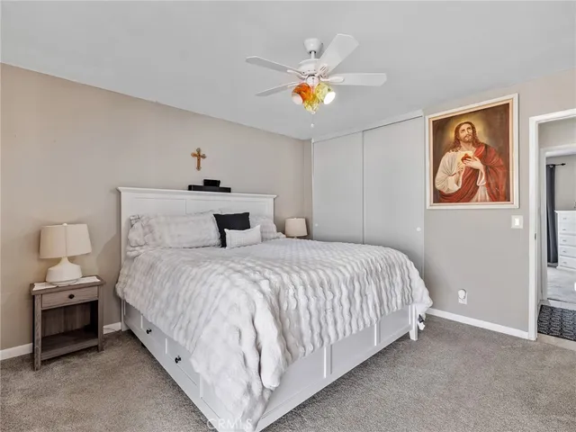 a spacious bedroom with a bed and a window