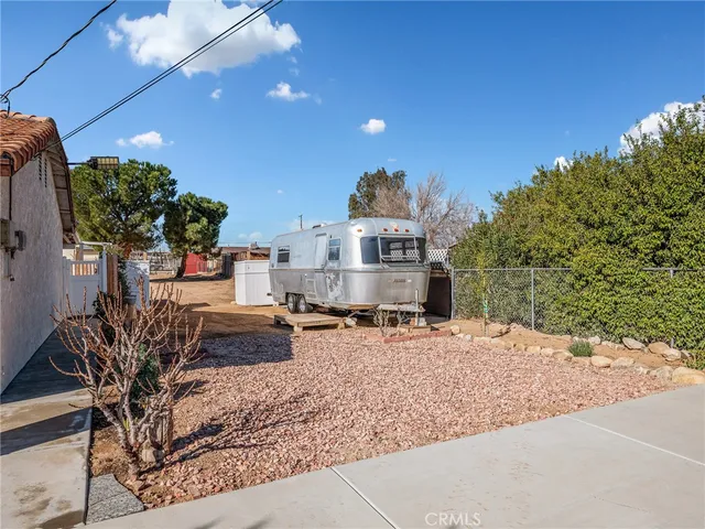 a living room with patio furniture and a potted plant