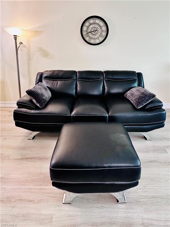 72 7th Street South, Unit 306 Naples, FL 34102 - Photo 11 of 23 a living room with a bed