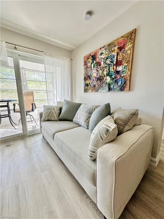 72 7th Street South, Unit 306 Naples, FL 34102 - Photo 13 of 23 a living room with furniture and a large window