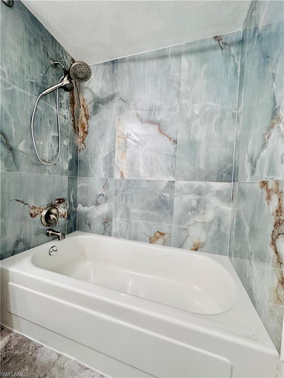 72 7th Street South, Unit 306 Naples, FL 34102 - Photo 21 of 23 a bathroom with a bathtub and a shower