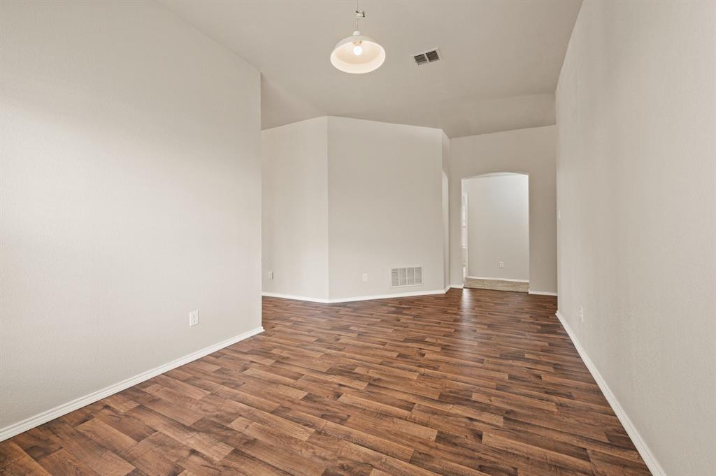 5509 Timber Ridge Court Watauga, TX 76137 - Photo 5 of 28 Wood-finish flooring throughout, complemented by light-toned wall finishes and a ceiling-mounted light fixture