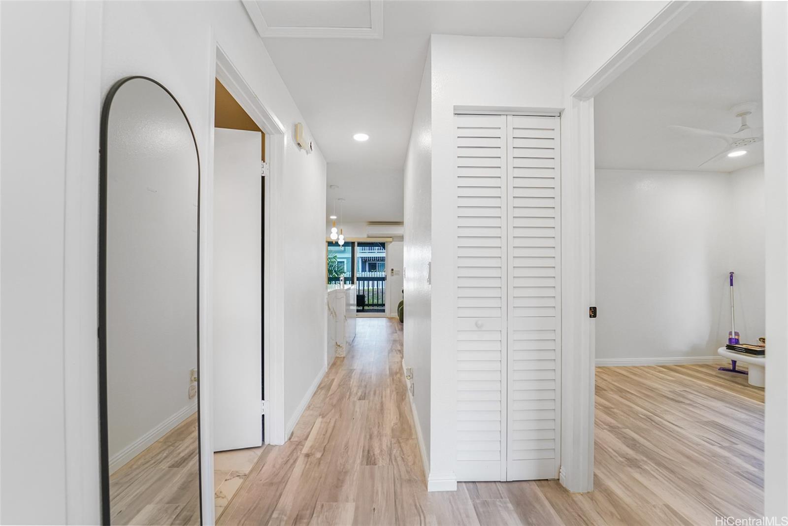 94-828 Lumiauau Street, Unit M204 Waipahu, HI 96797 - Photo 14 of 25 a view of a hallway with wooden floor and staircase