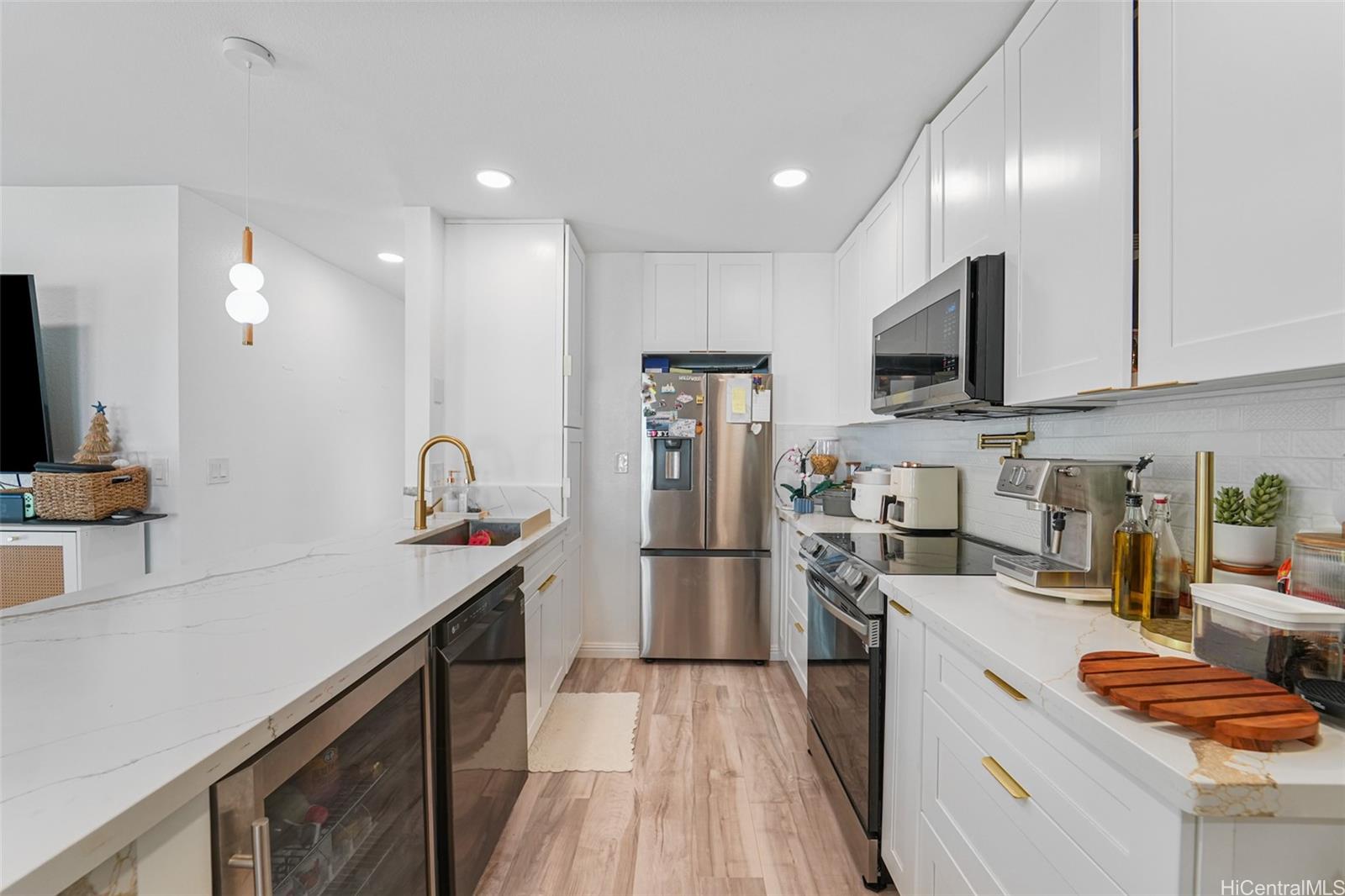 94-828 Lumiauau Street, Unit M204 Waipahu, HI 96797 - Photo 18 of 25 a kitchen with stainless steel appliances granite countertop a sink stove and refrigerator