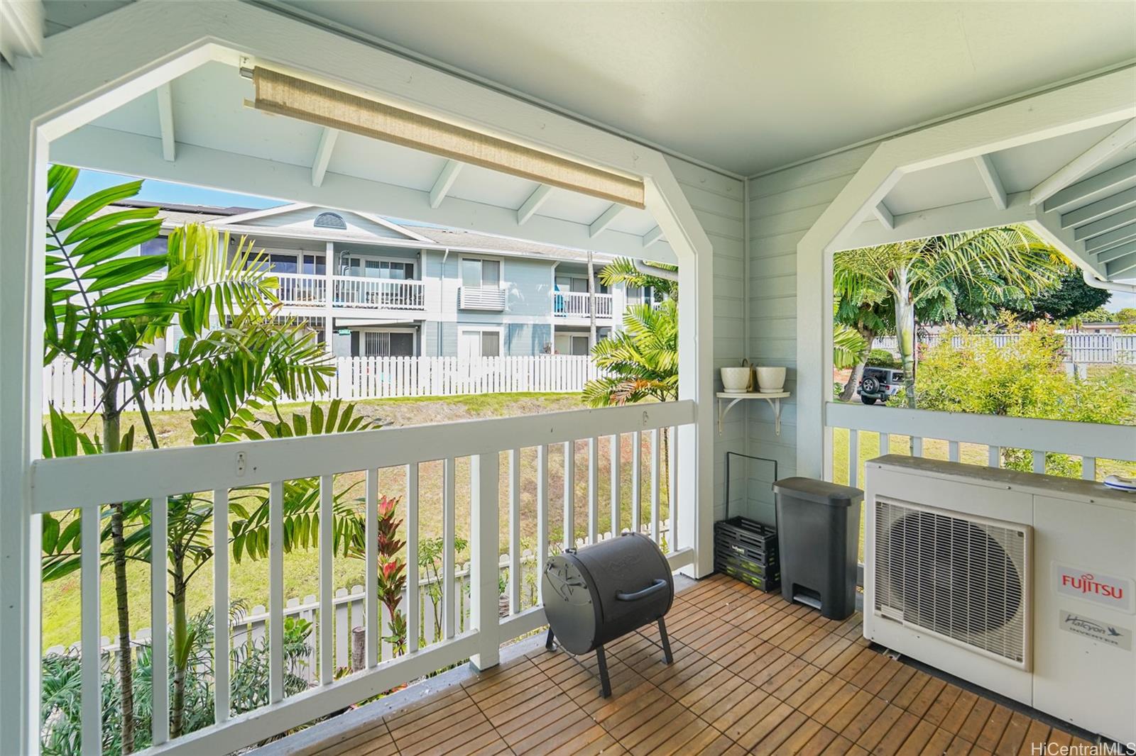 94-828 Lumiauau Street, Unit M204 Waipahu, HI 96797 - Photo 19 of 25 a view of a balcony with wooden floor