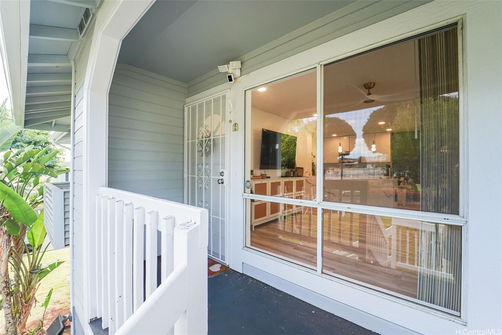 94-828 Lumiauau Street, Unit M204 Waipahu, HI 96797 - Photo 20 of 25 a view of a porch with a glass door and wooden floor