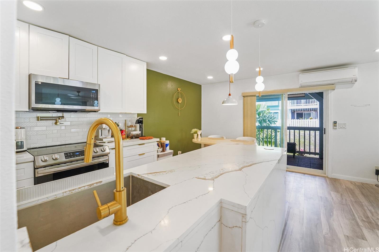 94-828 Lumiauau Street, Unit M204 Waipahu, HI 96797 - Photo 2 of 25 a kitchen with stainless steel appliances kitchen island granite countertop a stove and a sink with granite countertops