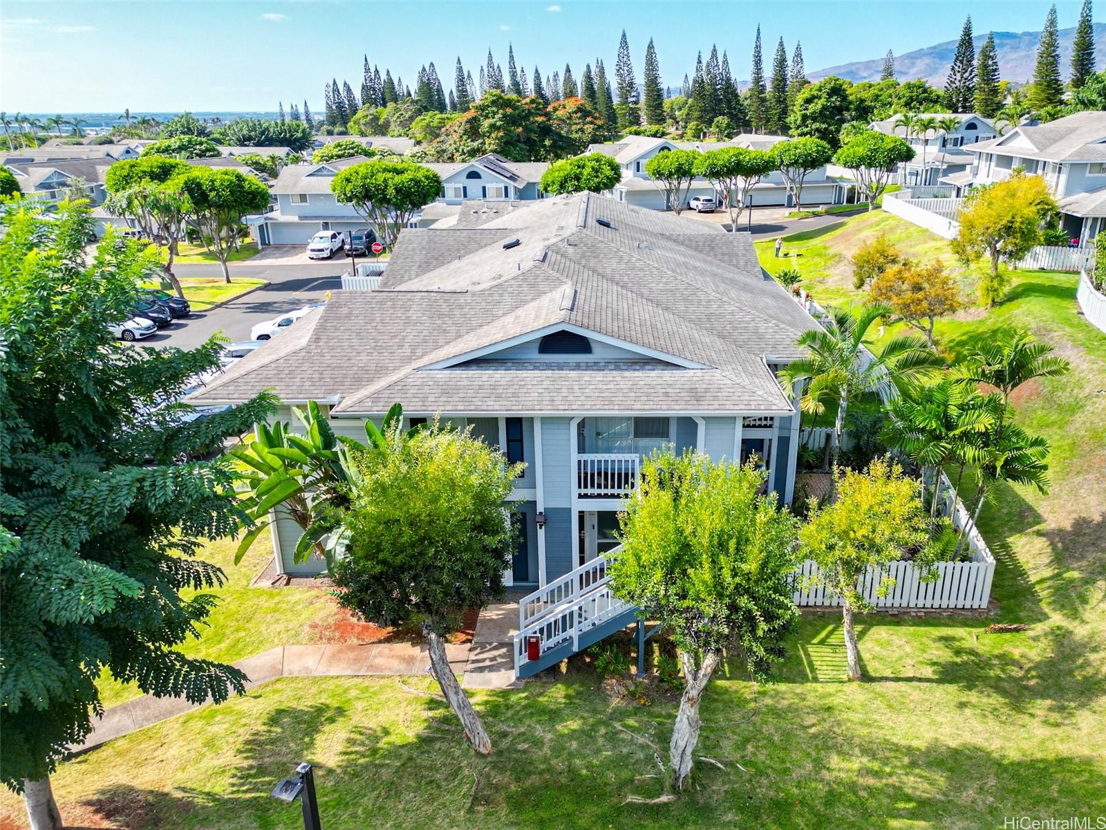 94-828 Lumiauau Street, Unit M204 Waipahu, HI 96797 - Photo 23 of 25 a house with lots of trees in front of it