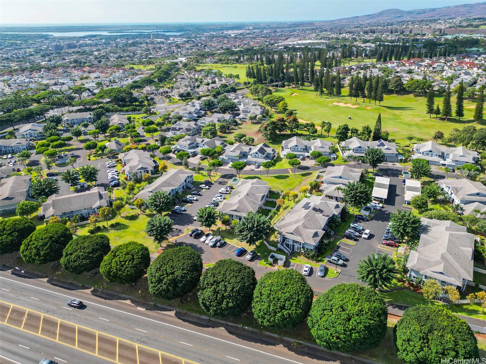 94-828 Lumiauau Street, Unit M204 Waipahu, HI 96797 - Photo 24 of 25 an aerial view of a houses with a yard and lake view