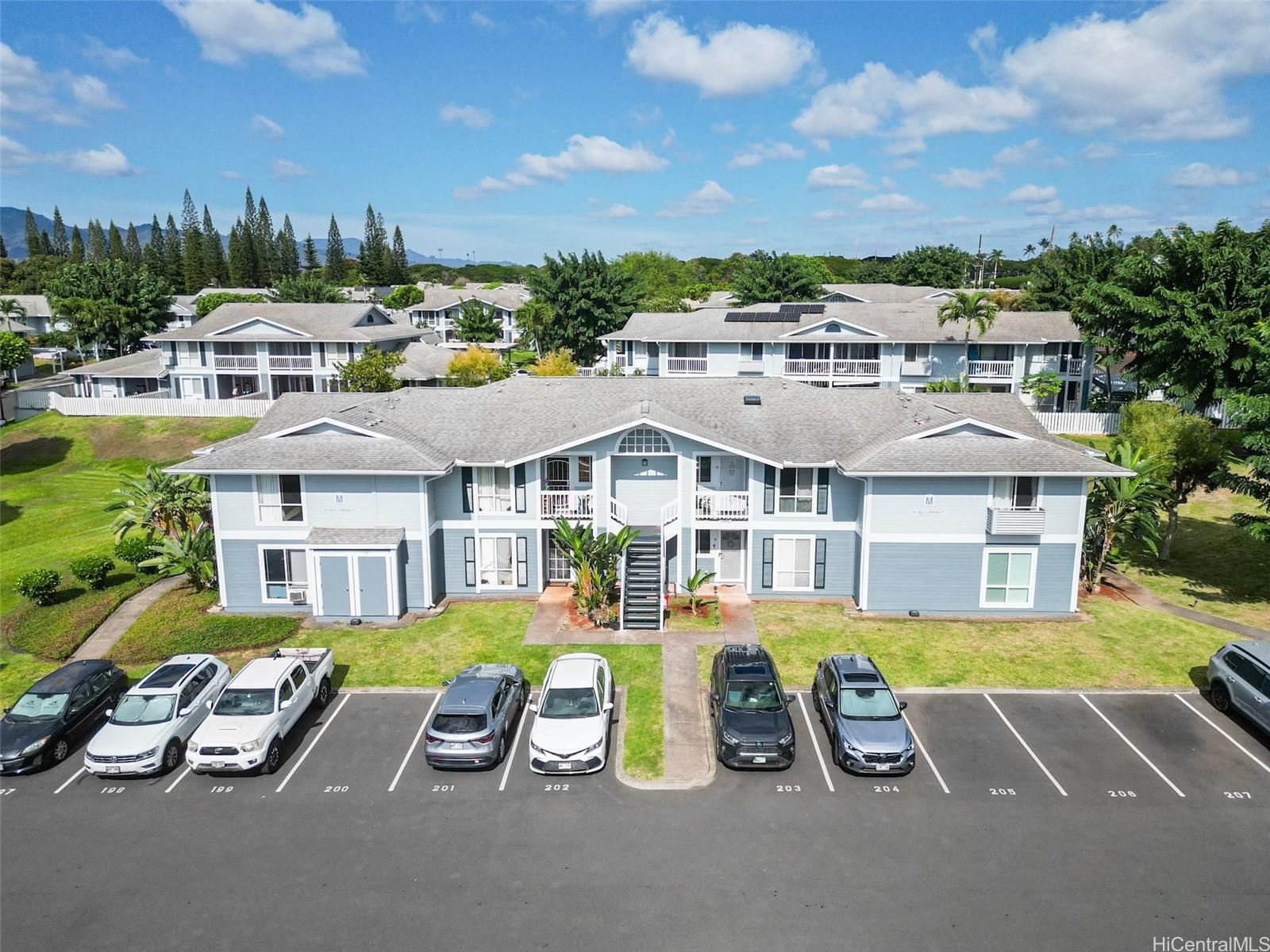 94-828 Lumiauau Street, Unit M204 Waipahu, HI 96797 - Photo 25 of 25 an aerial view of a house with swimming pool and a yard