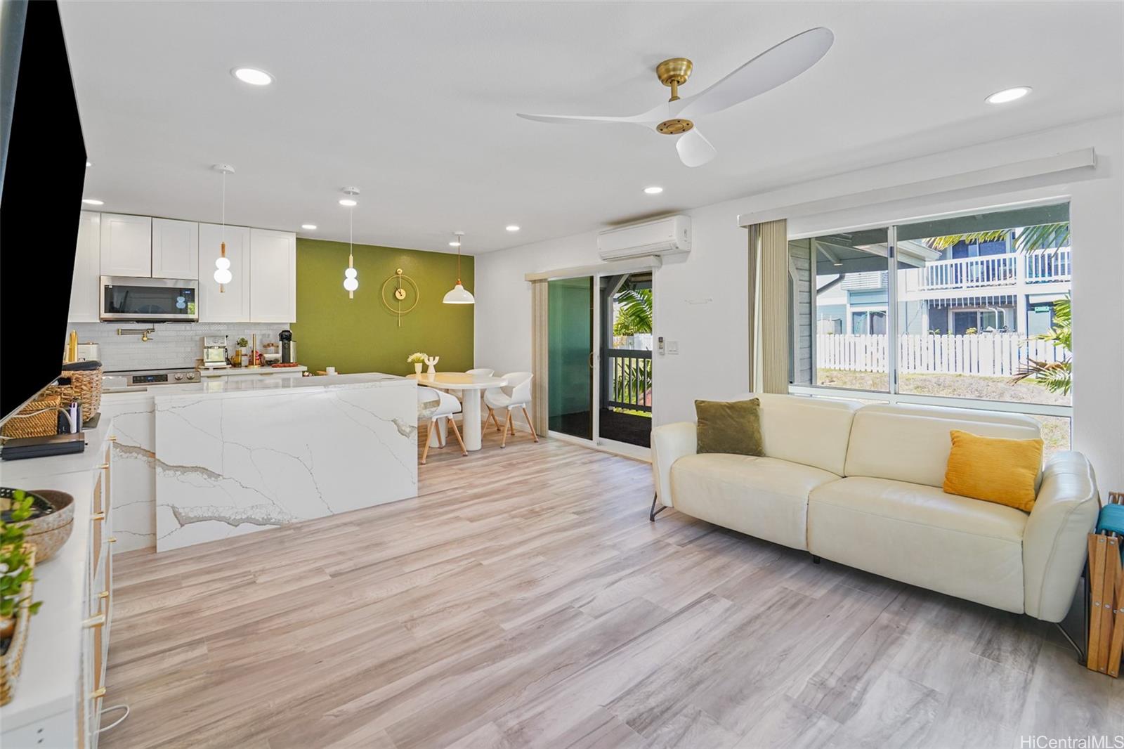 94-828 Lumiauau Street, Unit M204 Waipahu, HI 96797 - Photo 3 of 25 a living room with furniture and a flat screen tv