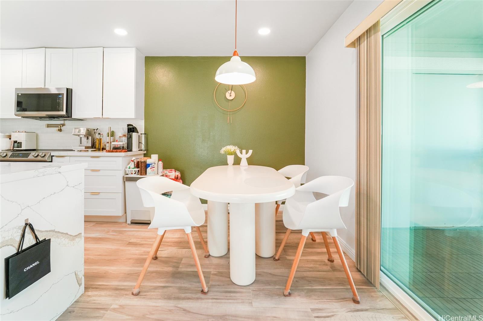 94-828 Lumiauau Street, Unit M204 Waipahu, HI 96797 - Photo 4 of 25 a dining room with wooden floor and stainless steel appliances