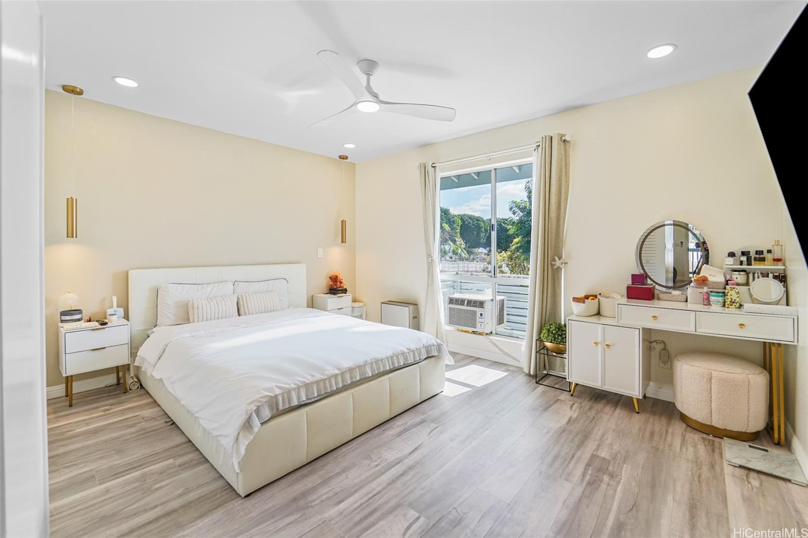 94-828 Lumiauau Street, Unit M204 Waipahu, HI 96797 - Photo 7 of 25 a bedroom with a large bed and a sink