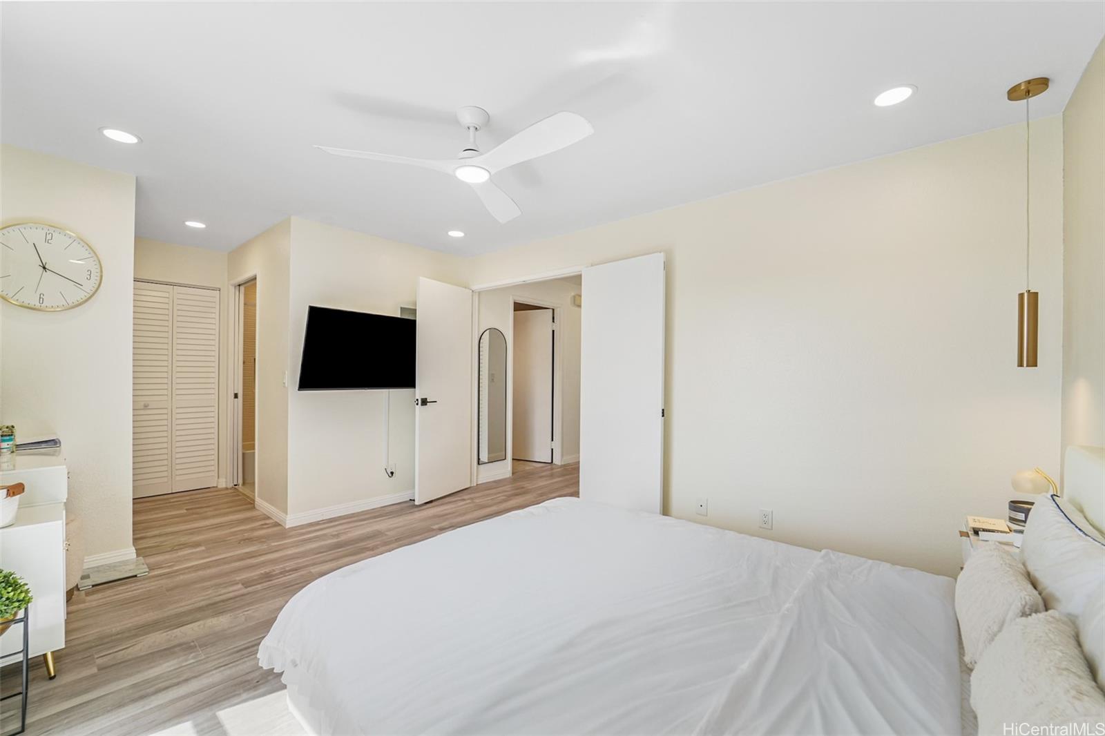 94-828 Lumiauau Street, Unit M204 Waipahu, HI 96797 - Photo 8 of 25 a bedroom with a bed and a flat screen tv