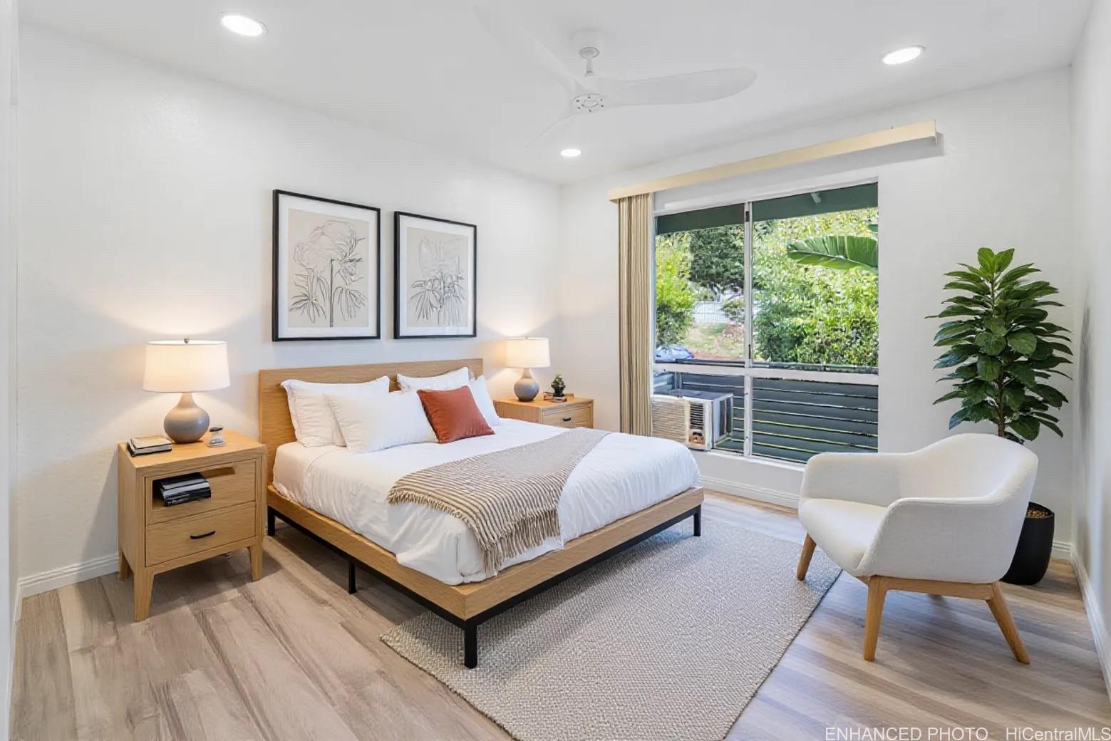 94-828 Lumiauau Street, Unit M204 Waipahu, HI 96797 - Photo 9 of 25 a bedroom with a bed and a chair