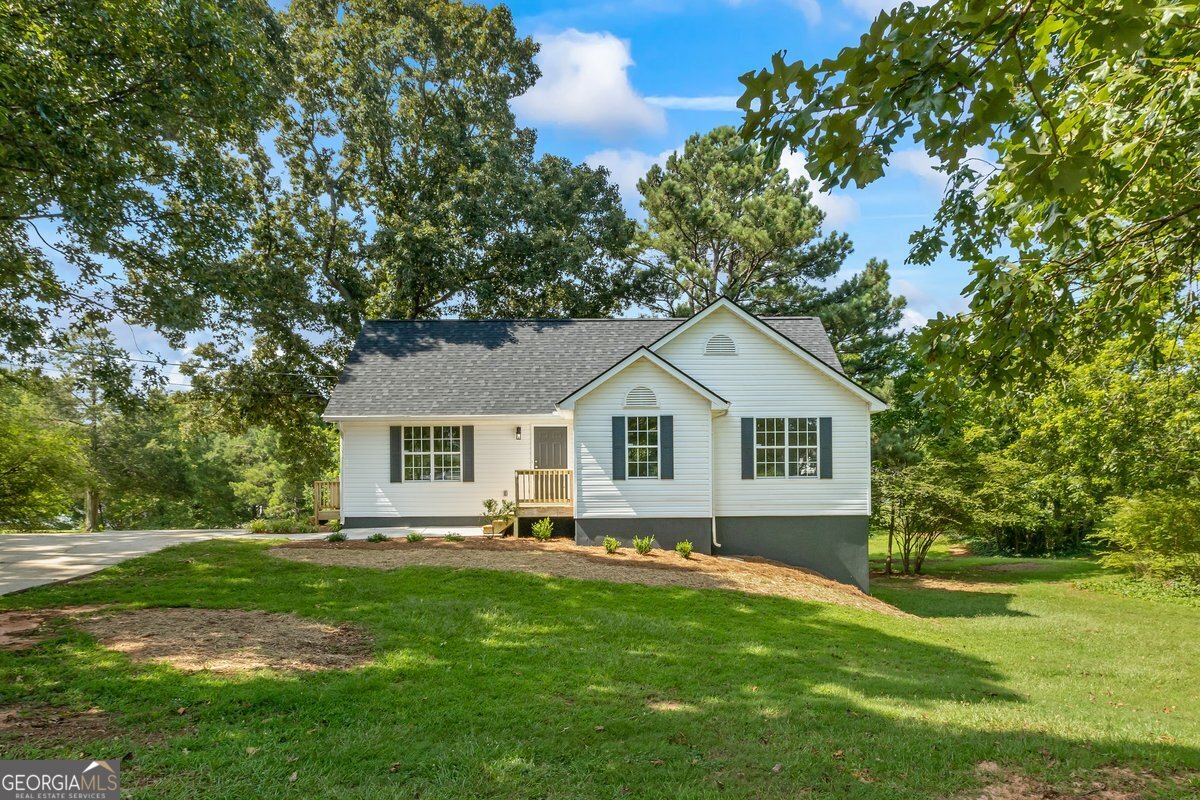 a front view of house with yard and green space