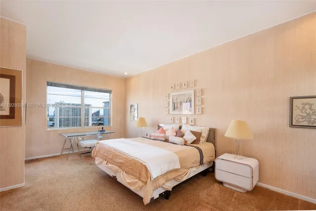 a bedroom with a bed and a large window