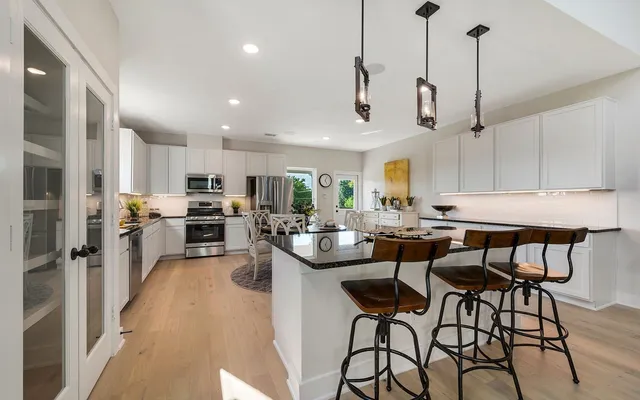 a kitchen with stainless steel appliances kitchen island granite countertop a sink and cabinets