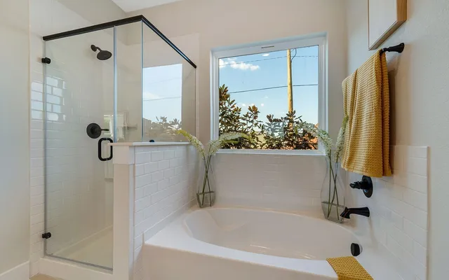 a bathroom with a tub and shower