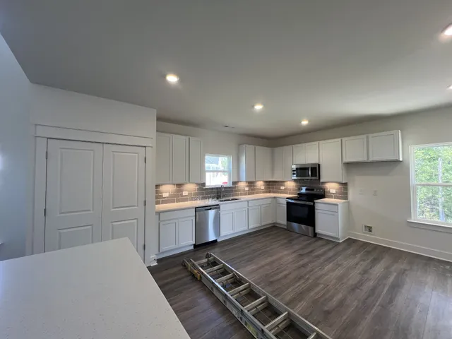 a kitchen with sink refrigerator and stove