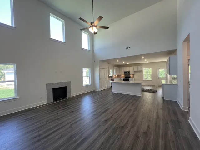a view of a kitchen with wooden floor and a window