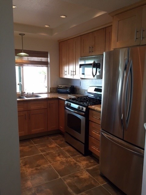 822 Bluewater Road Carlsbad, CA 92011 - Photo 10 of 24 Tile flooring, new cabinets, granite countertops, stainless steel appliances. Bosch dishwasher, gas stove, extra deep sink, breakfast counter, and recessed lighting.