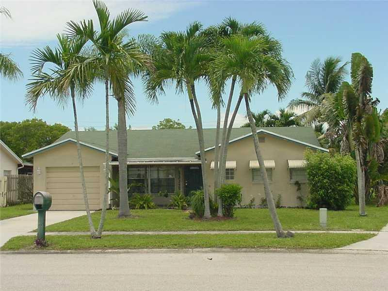22729 Southwest 56th Avenue Boca Raton, FL 33433 - Photo 1 of 24 a house that has a palm tree in front of it