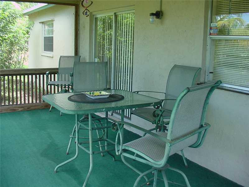 22729 Southwest 56th Avenue Boca Raton, FL 33433 - Photo 16 of 24 a balcony with table and chairs