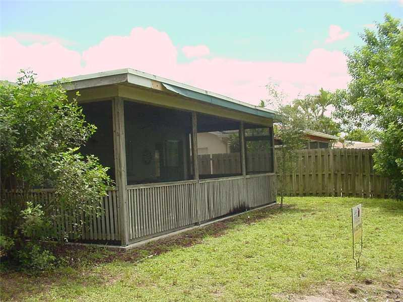 22729 Southwest 56th Avenue Boca Raton, FL 33433 - Photo 18 of 24 a view of a small house with wooden fence