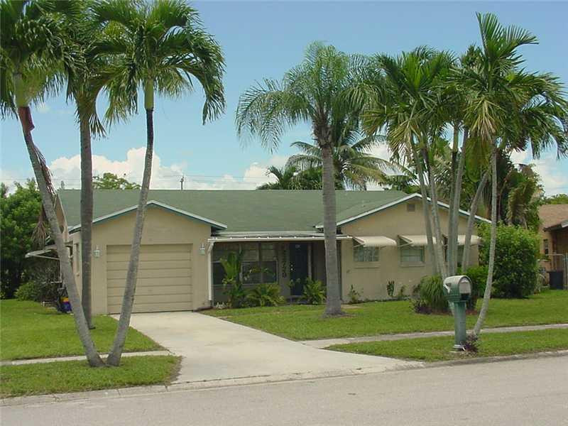 22729 Southwest 56th Avenue Boca Raton, FL 33433 - Photo 21 of 24 a white house with palm tree in front of it