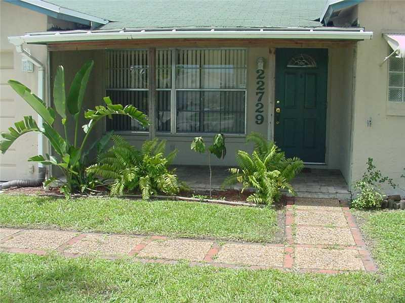 22729 Southwest 56th Avenue Boca Raton, FL 33433 - Photo 24 of 24 a front view of a house with a yard