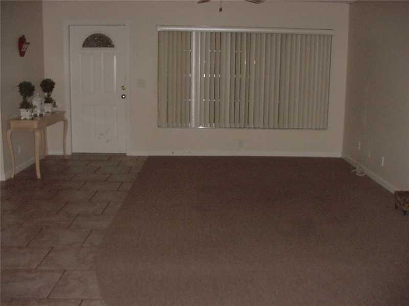 22729 Southwest 56th Avenue Boca Raton, FL 33433 - Photo 3 of 24 a view of wooden floor and windows in a room