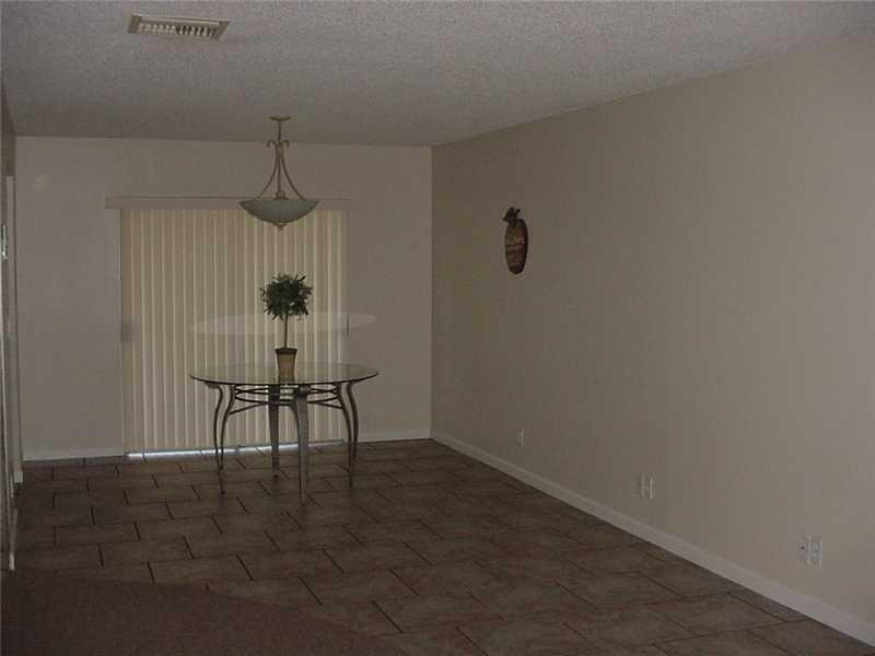 22729 Southwest 56th Avenue Boca Raton, FL 33433 - Photo 5 of 24 a room with a table and a chair