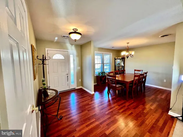 a view of a a dining room with furniture and wooden floor