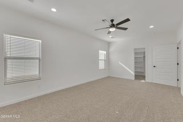 a view of walk in closet with empty racks