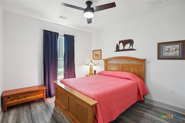 a bed sitting in a bedroom next to a window