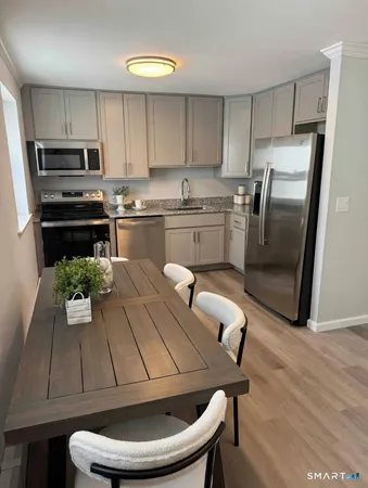 a kitchen with a sink appliances and cabinets