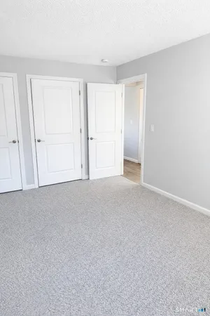 a view of an empty room and closet area