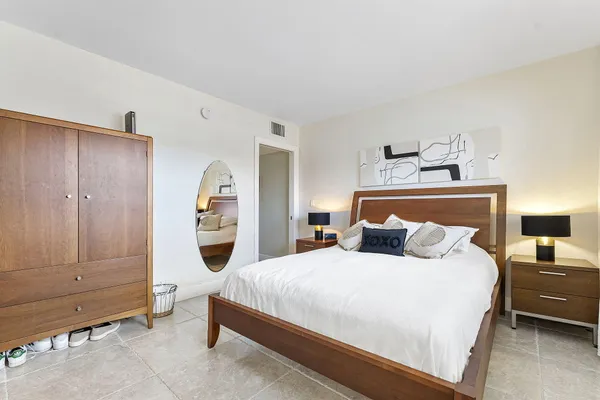 a bedroom with a large bed and a window
