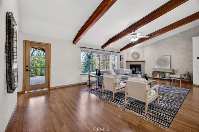 a living room with lots of furniture and wooden floor