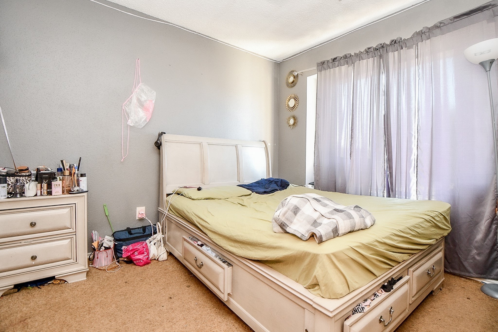 8628 Beechcrest Street Houston, TX 77083 - Photo 12 of 20 a bedroom with a bed and a chandelier