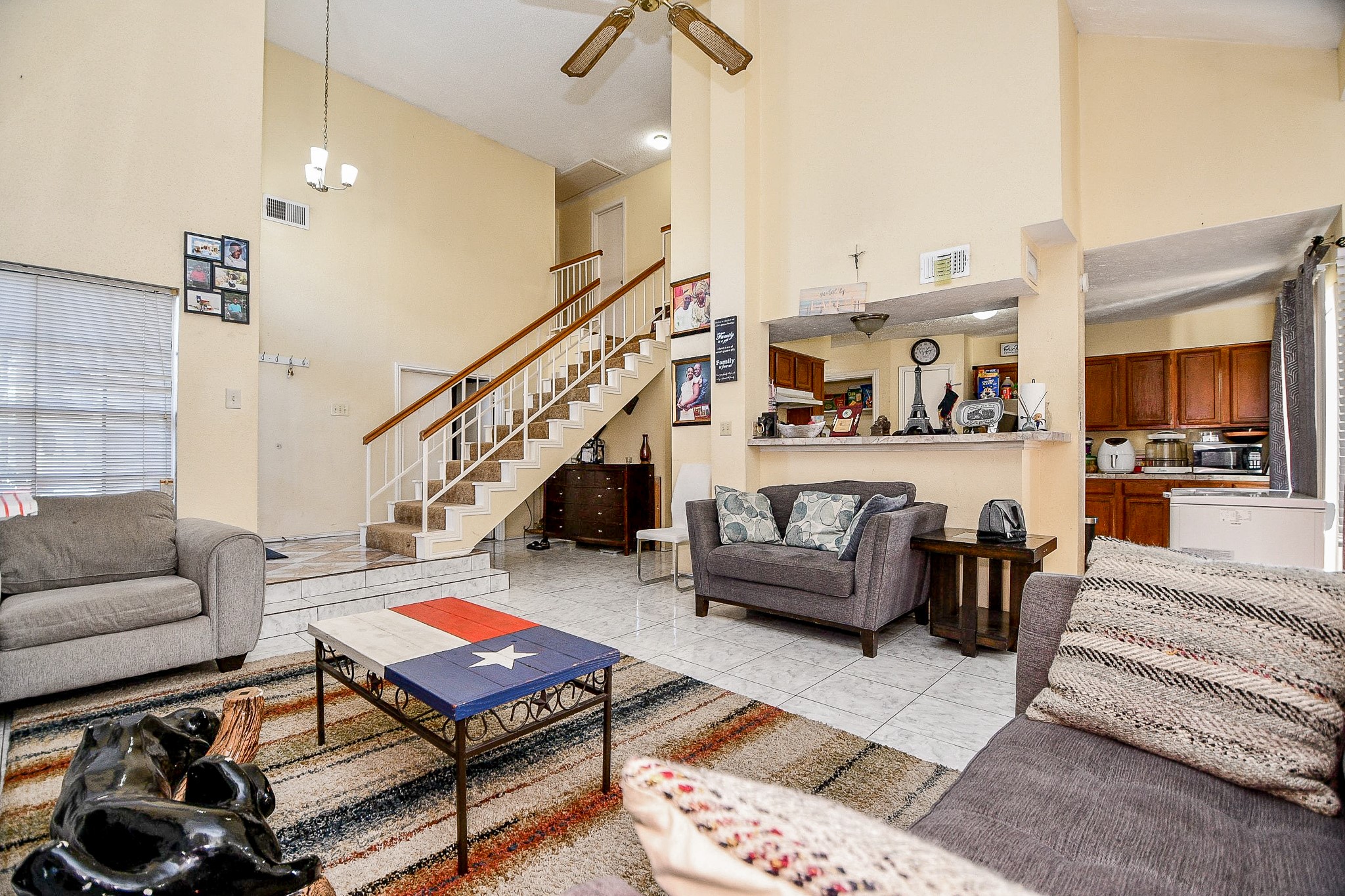 8628 Beechcrest Street Houston, TX 77083 - Photo 5 of 20 a living room with furniture and a dining table with wooden floor