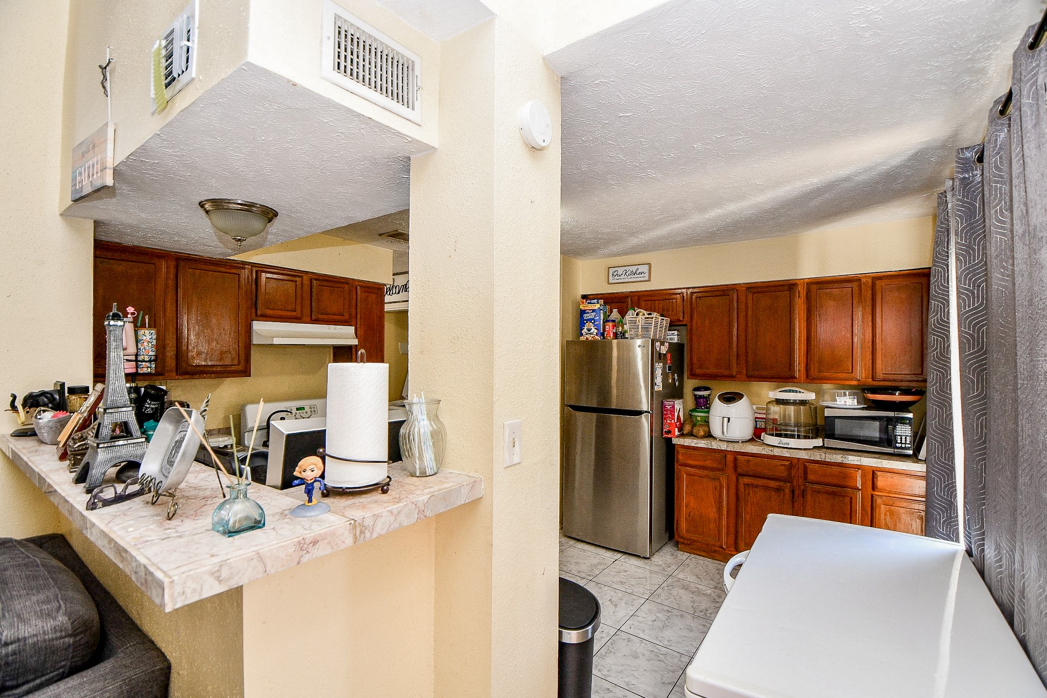 8628 Beechcrest Street Houston, TX 77083 - Photo 6 of 20 a kitchen with kitchen island a sink appliances and cabinets
