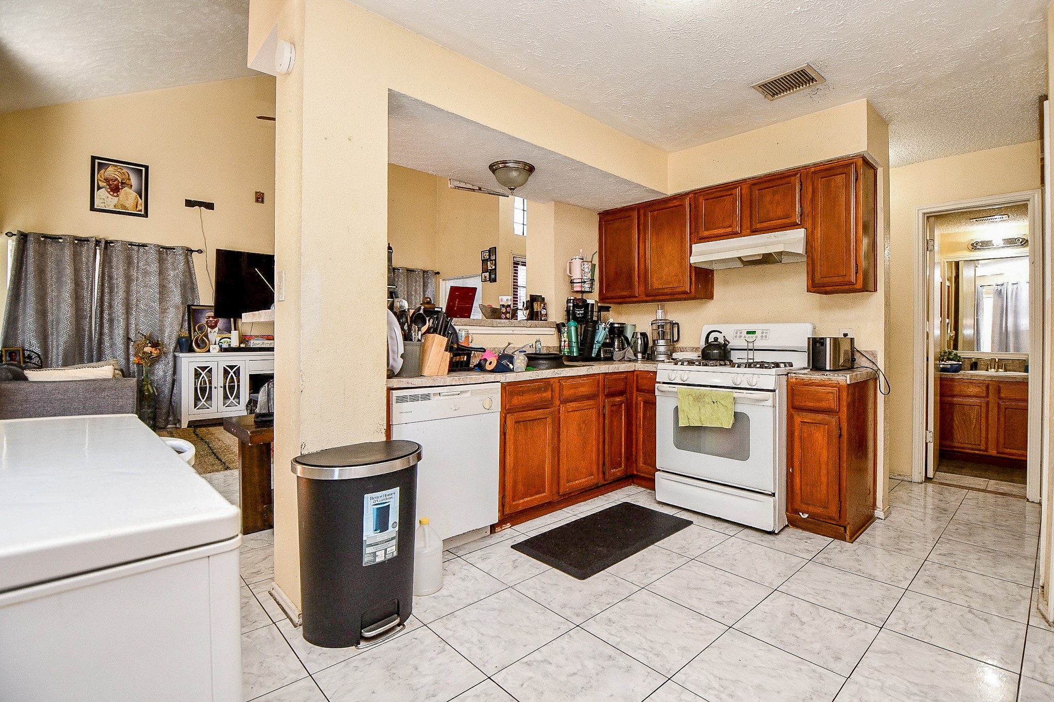 8628 Beechcrest Street Houston, TX 77083 - Photo 7 of 20 a kitchen with a stove top oven and cabinets